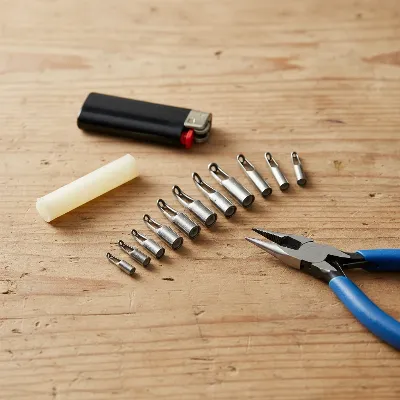 A fishing rod tip repair kit laid out on a table with various tip guides, a lighter, and a glue stick.